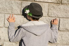 Rear view of young teen girl in gray jacket standing next to th. Back view of young teen girl in gray jacket standing next to the stone grey wall. Concept Royalty Free Stock Images Rear view of young teen girl in gray jacket standing next to th. Back view of young teen girl in gray jacket standing next to the stone grey wall. Concept Royalty Free Stock Images