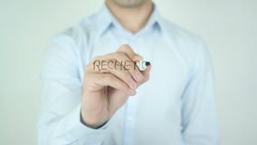Recherche D'Emploi, job Search writing in French on Glass. Man writing Recherche D'Emploi, job Search writing in French on Glass. Man writing