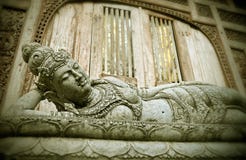 Reclining and sleeping Buddha Balinese religious statue in Ubud in the Island of Bali , Indonesia at the gate of temple in Buddhis stock images Reclining and sleeping Buddha Balinese religious statue in Ubud in the Island of Bali , Indonesia at the gate of temple in Buddhis stock images