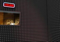 Recording studio. Interior with on air sign and editing room window Recording studio. Interior with on air sign and editing room window
