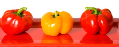 Red And Yellow Bell Peppers On A Red Plate. Royalty Free Stock Photo