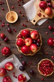 Red apples with plums and cranberries Stock Photography Red apples with plums and cranberries Stock Photography