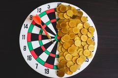 Red arrow dart board on Gold coin money for business success stock photo Red arrow dart board on Gold coin money for business success stock photo