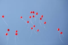 Red balloons in the sky