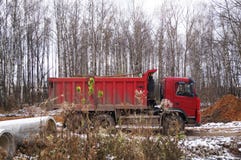 Red car - dump truck at work stock photography Red car - dump truck at work stock photography