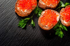 Red caviar on slate background. stock image Red caviar on slate background. stock image