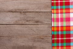 Red checkered tablecloth on an old wooden table with copy space for your text. Top view Stock Images Red checkered tablecloth on an old wooden table with copy space for your text. Top view Stock Images