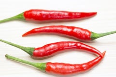 Red chili on the light brown wooden. The red chili on the light brown wooden background Royalty Free Stock Image Red chili on the light brown wooden. The red chili on the light brown wooden background Royalty Free Stock Image