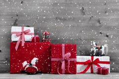 Red Christmas presents and gift boxes with rocking horse on grey stock image Red Christmas presents and gift boxes with rocking horse on grey stock image