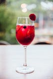 Red cocktail filled blackberry and sliced of lime with fresh strawberry on the glass Royalty Free Stock Photography Red cocktail filled blackberry and sliced of lime with fresh strawberry on the glass Royalty Free Stock Photography