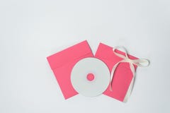 Red envelope with yellow ribbon in the shape of a bow for CD, vertical position . square envelope stock image Red envelope with yellow ribbon in the shape of a bow for CD, vertical position . square envelope stock image