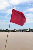 Red flag with blowing wind beside Chaophraya River. stock photography Red flag with blowing wind beside Chaophraya River. stock photography