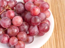Red Grape Branch In White Plate On Straw Tray Clo Royalty Free Stock Photos