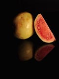 RED GUAVA ISOLATED ON BLACK BACKGROUND stock image RED GUAVA ISOLATED ON BLACK BACKGROUND stock image