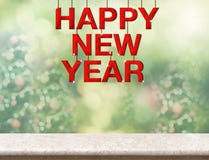 Red happy new year wood word hanging over marble table top with royalty free stock image Red happy new year wood word hanging over marble table top with royalty free stock image