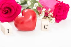 Red heart and roses, and wooden cubes with letters I and U, on white background. stock photo Red heart and roses, and wooden cubes with letters I and U, on white background. stock photo