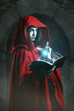 Red hooded woman casting powerful magic