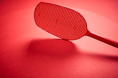 Red isolated plastic fly trap on intense colored background