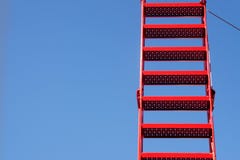 Red ladder from metal against the blue sky, generous copy spac