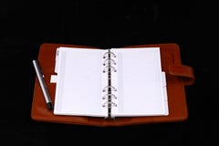 Red leather notebook with silver pen Red leather notebook with silver pen