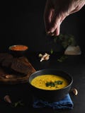Red Lentil Soup, Spices, Herbs, Vegetables And Cream. Soup On A Blue Napkin, Next To Brown Bread, Garlic, A Bowl With Lentils. Stock Photo Red Lentil Soup, Spices, Herbs, Vegetables And Cream. Soup On A Blue Napkin, Next To Brown Bread, Garlic, A Bowl With Lentils. Stock Photo