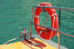 Red lifebuoy hanging on railings of rescue boat Stock Image Red lifebuoy hanging on railings of rescue boat Stock Image