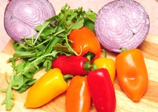 Red, Orange And Yellow Peppers, Onions And Salad Stock Photo
