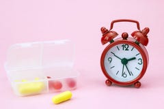 Red pharmaceutical pills, tablets and yellow capsules spilling out of daily pill box with red alarm clock. Medical conceptual phot stock images Red pharmaceutical pills, tablets and yellow capsules spilling out of daily pill box with red alarm clock. Medical conceptual phot stock images