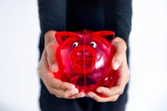 Red pig money box in the hands of a dark-skinned girl stock images Red pig money box in the hands of a dark-skinned girl stock images