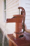 Red Pitcher Pump with Child Hand stock photo Red Pitcher Pump with Child Hand stock photo