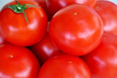Red ripe juicy tomatoes with green leaves close up stock photo Red ripe juicy tomatoes with green leaves close up stock photo