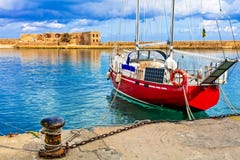 Red sailing boat in old town of Chania, Crete island, Greece stock photo Red sailing boat in old town of Chania, Crete island, Greece stock photo