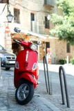Red scooter parked in the street in the european sity royalty free stock image Red scooter parked in the street in the european sity royalty free stock image