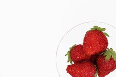 Red strawberry in a glass glass glass on a white background close-up. imitation strawberries. place for text. stock photography Red strawberry in a glass glass glass on a white background close-up. imitation strawberries. place for text. stock photography