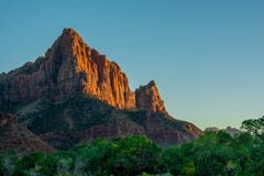 Red Sunset in Zion National Park green and orange colours with blue sky royalty free stock photography Red Sunset in Zion National Park green and orange colours with blue sky royalty free stock photography