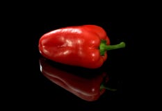 Red paprika on a black background, with reflection. stock images Red paprika on a black background, with reflection. stock images