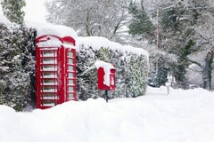 Red telephone and post box in the snow