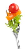 Red Tomato And Salad On A Fork Royalty Free Stock Images
