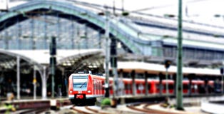 Red Train at a Green Train Station on an Overcast Day Royalty Free Stock Photo Red Train at a Green Train Station on an Overcast Day Royalty Free Stock Photo