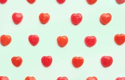 Red Valentine`s day heart candy pattern on green pastel paper color background. Love Concept. colorful hipster style. top view. Stock Images Red Valentine`s day heart candy pattern on green pastel paper color background. Love Concept. colorful hipster style. top view. Stock Images