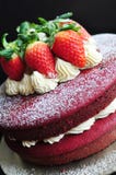 Red velvet cake decorated with fresh strawberries