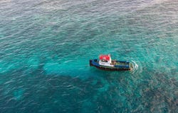 Red White and Blue Pilot Boat in Shallow Aqua Water. A red, white and blue pilot boat in the clear water of the Caribbean Stock Image Red White and Blue Pilot Boat in Shallow Aqua Water. A red, white and blue pilot boat in the clear water of the Caribbean Stock Image