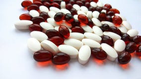 Assorted red and white pharmaceutical medicine pills, tablets and capsules on white background. Pharmacy theme, health care, drug stock photo Assorted red and white pharmaceutical medicine pills, tablets and capsules on white background. Pharmacy theme, health care, drug stock photo