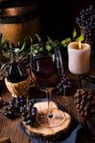Red wine from a barrel with grapes and a glass of wine Stock Photography Red wine from a barrel with grapes and a glass of wine Stock Photography