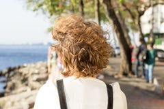 Redhead girl sitting on Mureta da Urca, Rio de Janeiro, Brazil, contemplating the sea. stock image Redhead girl sitting on Mureta da Urca, Rio de Janeiro, Brazil, contemplating the sea. stock image