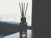 Reed freshener,close up. Aroma liquid in glass bottle with reed sticks.Selective focus. decor. Air freshener sticks at home.Air stock photo Reed freshener,close up. Aroma liquid in glass bottle with reed sticks.Selective focus. decor. Air freshener sticks at home.Air stock photo