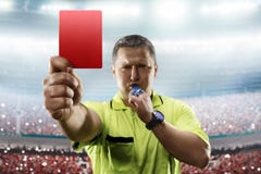 Referee showing the red card in the soccer stadium