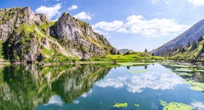 Reflection of clouds in the high mountain lake water Royalty Free Stock Images Reflection of clouds in the high mountain lake water Royalty Free Stock Images