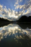 Reflection of dramatic clouds with sunrays royalty free stock images Reflection of dramatic clouds with sunrays royalty free stock images