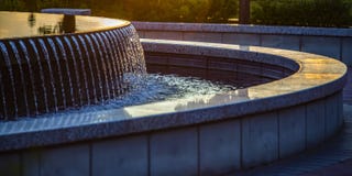 Reflective water of an outdoor fountain at sunset royalty free stock photography Reflective water of an outdoor fountain at sunset royalty free stock photography